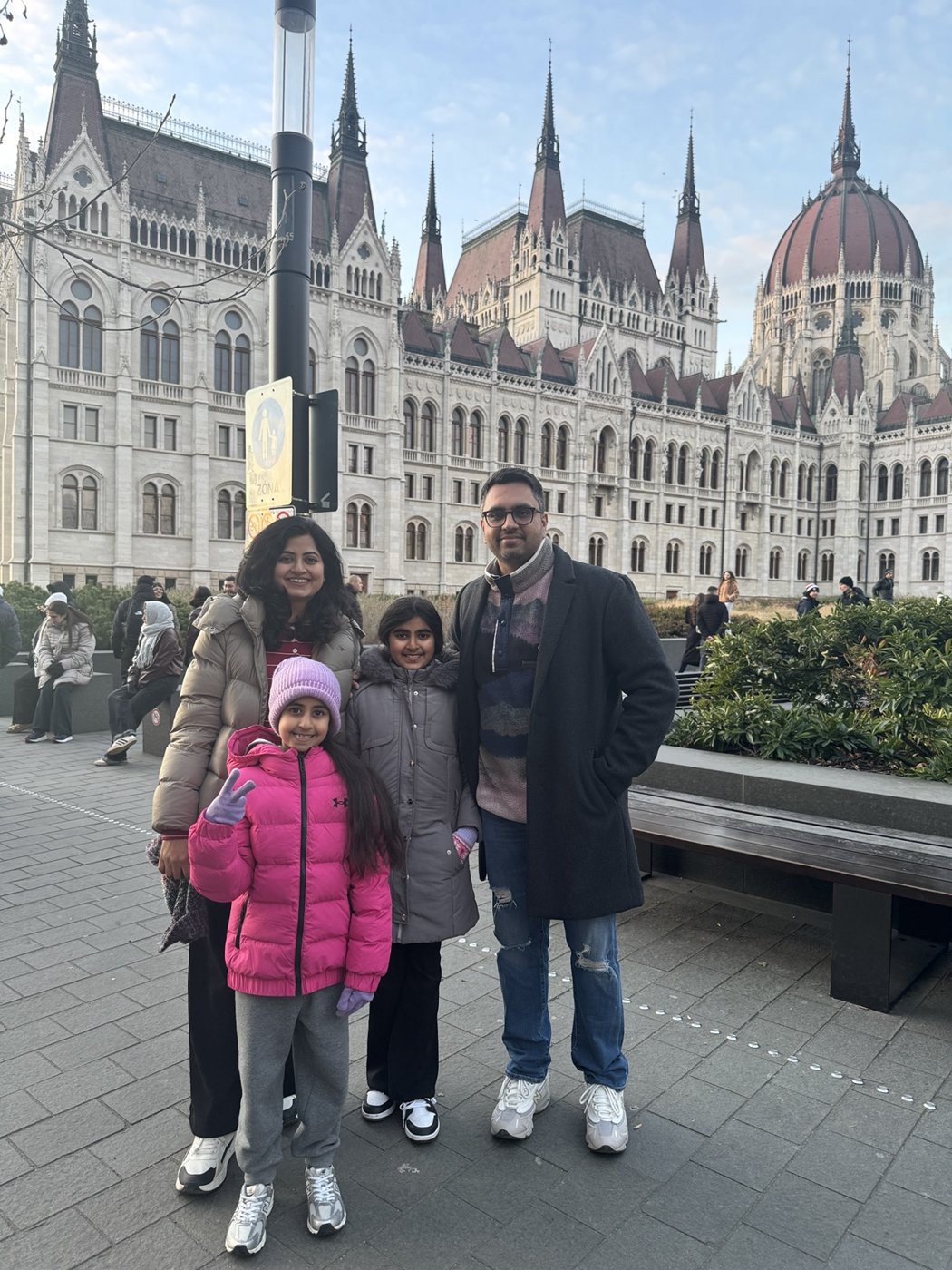 Aman with his family in front of the Hungarian Parliament in Budapest