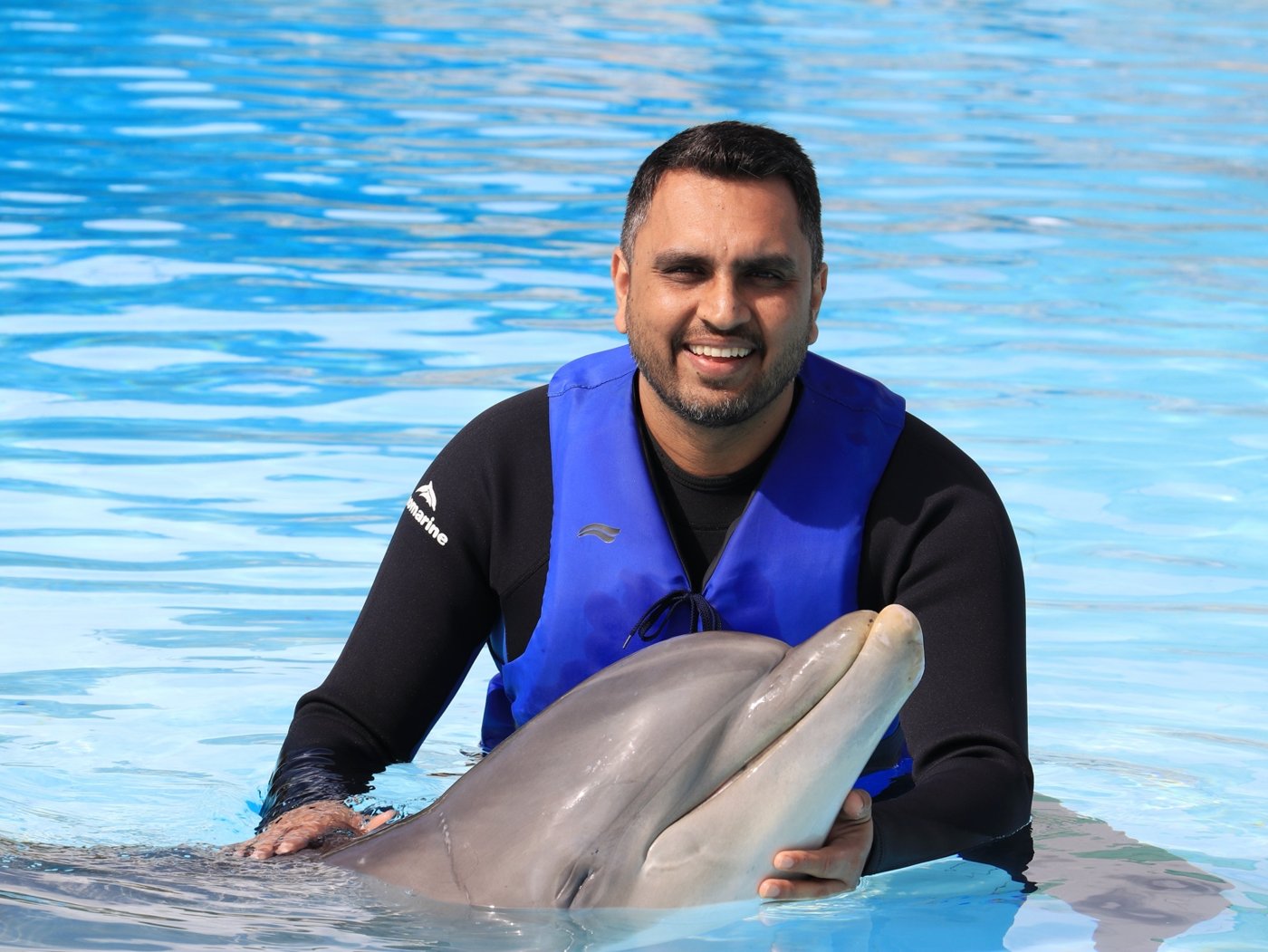 Aman meeting a dolphin during an experience in Portugal